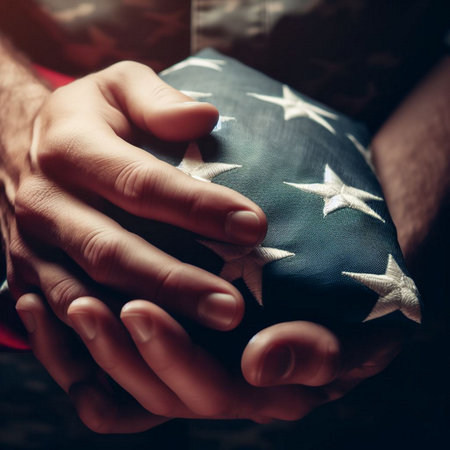 Close-up of man's hands holding American flag wrapped in a gift boxの素材