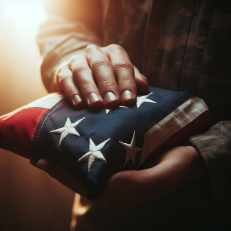 Patriotic American flag in hands of a soldier, close upの素材