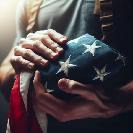Hands of a young man with a gift on the background of the American flagの素材