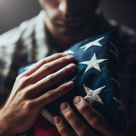 Close-up of a young man holding an american flag.の素材
