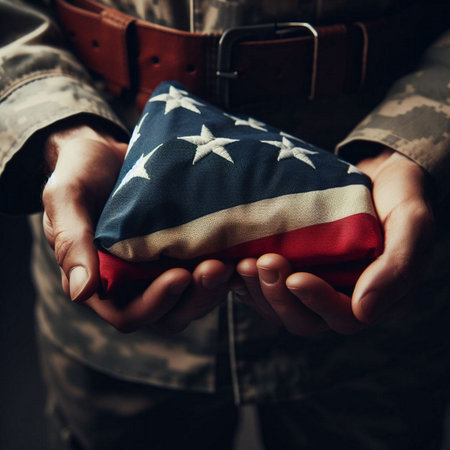 Close-up of a soldier holding an American flag in his handsの素材