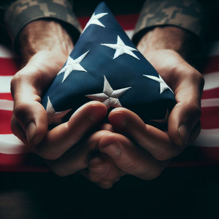 A close-up shot of a hand holding a folded American flagの素材