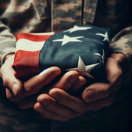 A close-up shot of a hand holding a folded American flagの素材