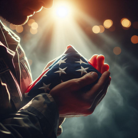 A close-up shot of a hand holding a folded American flagの素材
