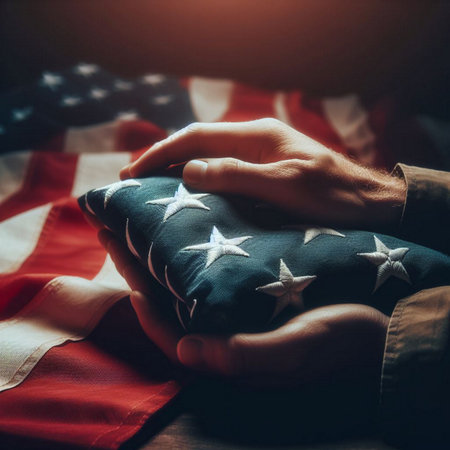 A close-up shot of a hand holding a folded American flagの素材