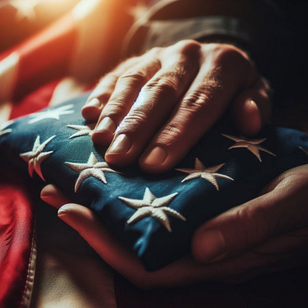 A close-up shot of a hand holding a folded American flagの素材