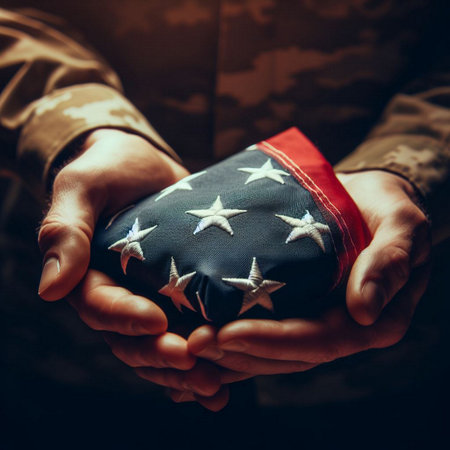 A close-up shot of a hand holding a folded American flagの素材