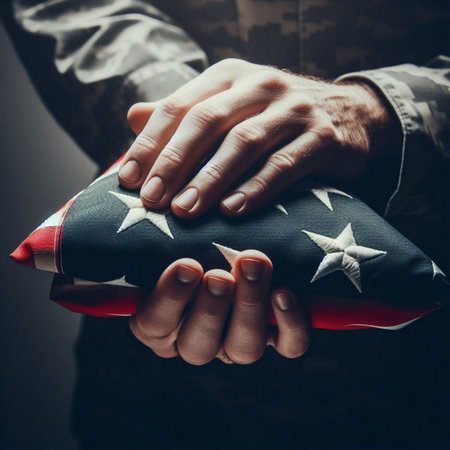 A close-up shot of a hand holding a folded American flagの素材