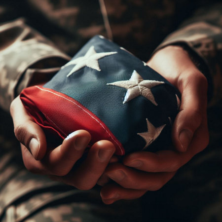 A close-up shot of a hand holding a folded American flagの素材