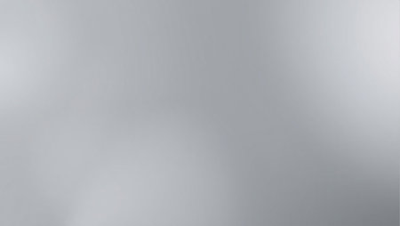 A blurry gray background with a few white circles. The background is mostly gray with some whiteの素材