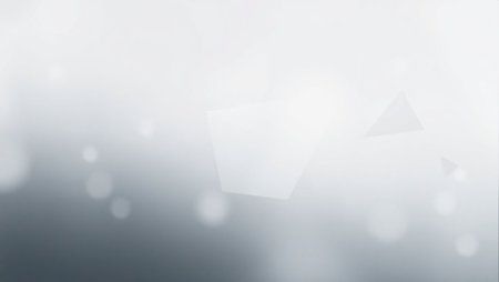 A blurry gray background with a few white circles. The background is mostly gray with some whiteの素材