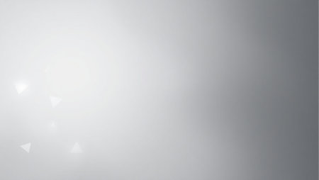A blurry gray background with a few white circles. The background is mostly gray with some whiteの素材