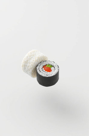 Sushi roll with salmon, caviar and avocado on white backgroundの素材