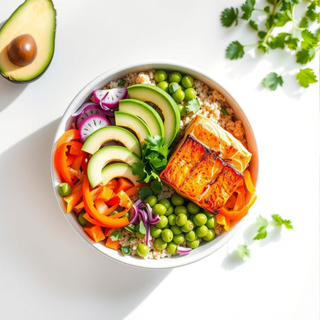 Buddha bowl with quinoa, avocado, fresh vegetables and salmon on white backgroundの素材
