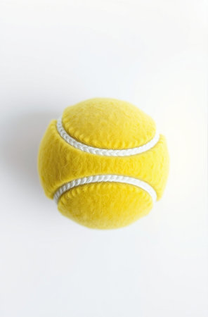 Yellow tennis ball on white background. Top view. Flat lay.の素材