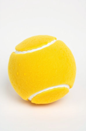 Yellow tennis ball isolated on white background. Close up. Selective focus.の素材