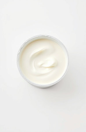 Yogurt in a plastic cup on a white background. Top view.の素材