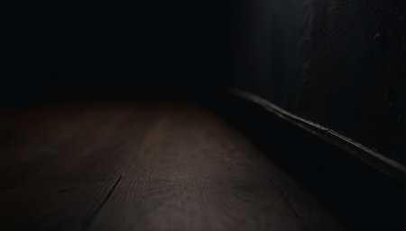 Wooden floor in a dark room. Dark background with copy space.の素材