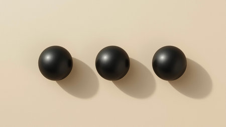 3d render of three black balls in a row on beige backgroundの素材
