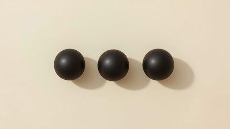Three black balls on a beige background. Minimalism.の素材