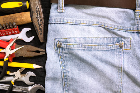 Tools in a blue jeans background and black backgroundの写真素材