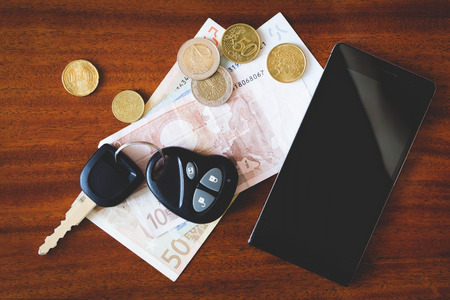 the contents of the pockets of men on a brown wooden tableの写真素材