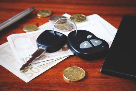 the contents of the pockets of men on a brown wooden tableの写真素材