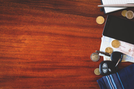 the contents of the pockets of men on a brown wooden table 