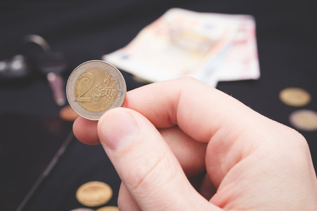 mans hand holding money on the black backgroundの写真素材