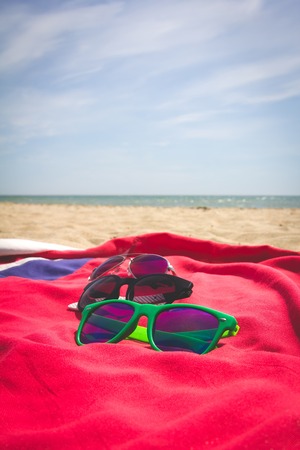 Sunglasses all family members lying on the beach against the seaの写真素材