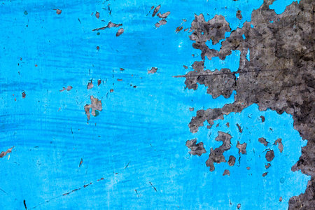 Cracked paint blue background with black and gray spotsの写真素材