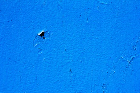Cracked paint blue background with black and gray spotsの写真素材