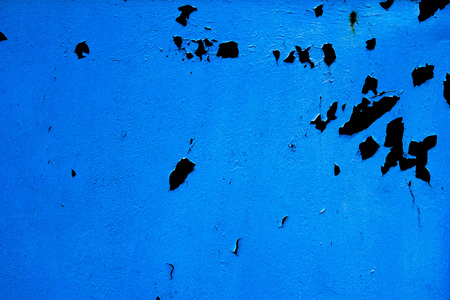Cracked paint blue background with black and gray spotsの写真素材