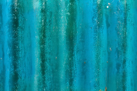 Slightly worn and scratched turquoise background with streaks of paintの写真素材