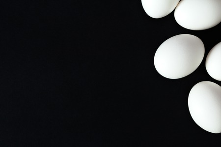 Several eggs on a black background. Top viewの写真素材