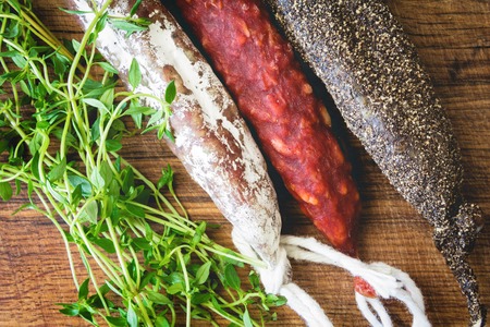 Three types of spanish sausages black, red and white on wooden board. Traditional spanish appetizer tapasの写真素材