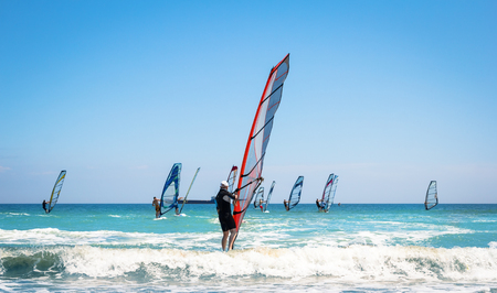 Windsurfing sails on the blue sea riding the windの写真素材