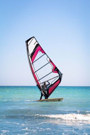 Windsurfing sails on the blue sea riding the windの写真素材