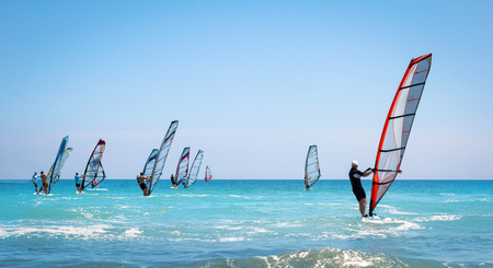 Windsurfing sails on the blue sea riding the windの写真素材