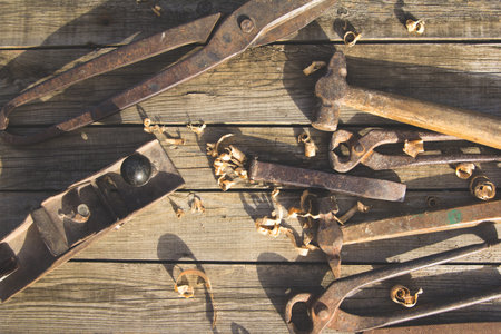 Rusty set of old hand tools on a wooden background. Vintage photo