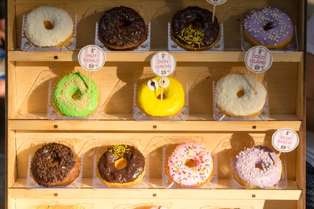 Different kinds of donuts in the store in sunset lightの写真素材