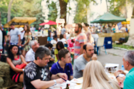 Abstract blur people picnic in public park with family or friends, urban leisure lifestyle. Streed food fest.の写真素材