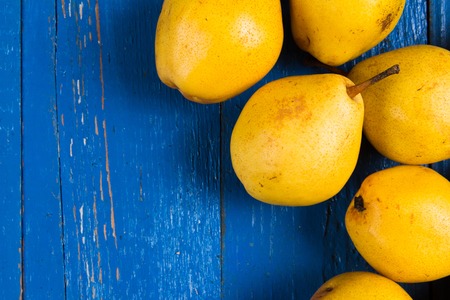 Juicy pears, fresh ripe organic pears on blue rustic wooden table, natural background, organic pears, diet food.の写真素材