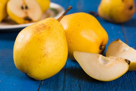 Juicy pears, fresh ripe organic pears on blue rustic wooden table, natural background, organic pears, diet food.の写真素材