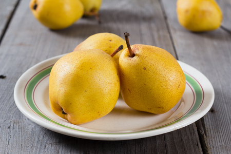 Juicy pears, fresh ripe organic pears on rustic wooden table, natural background, organic pears, diet food.の写真素材