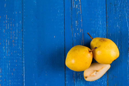 Juicy pears, fresh ripe organic pears on blue rustic wooden table, natural background, organic pears, diet food.の写真素材