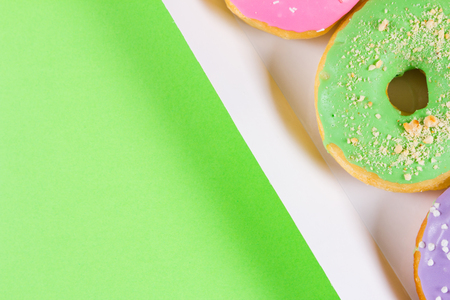 Six colorful round donuts in the box. Flat lay, top view.の写真素材