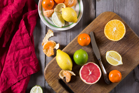 various types of citrus fruit on a dark wooden background. Classic Still Life