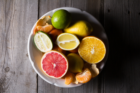 various types of citrus fruit on a dark wooden background. Classic Still Lifeの写真素材