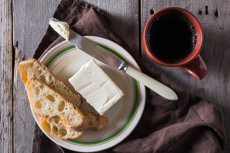 French baguette with butter for breakfastの写真素材